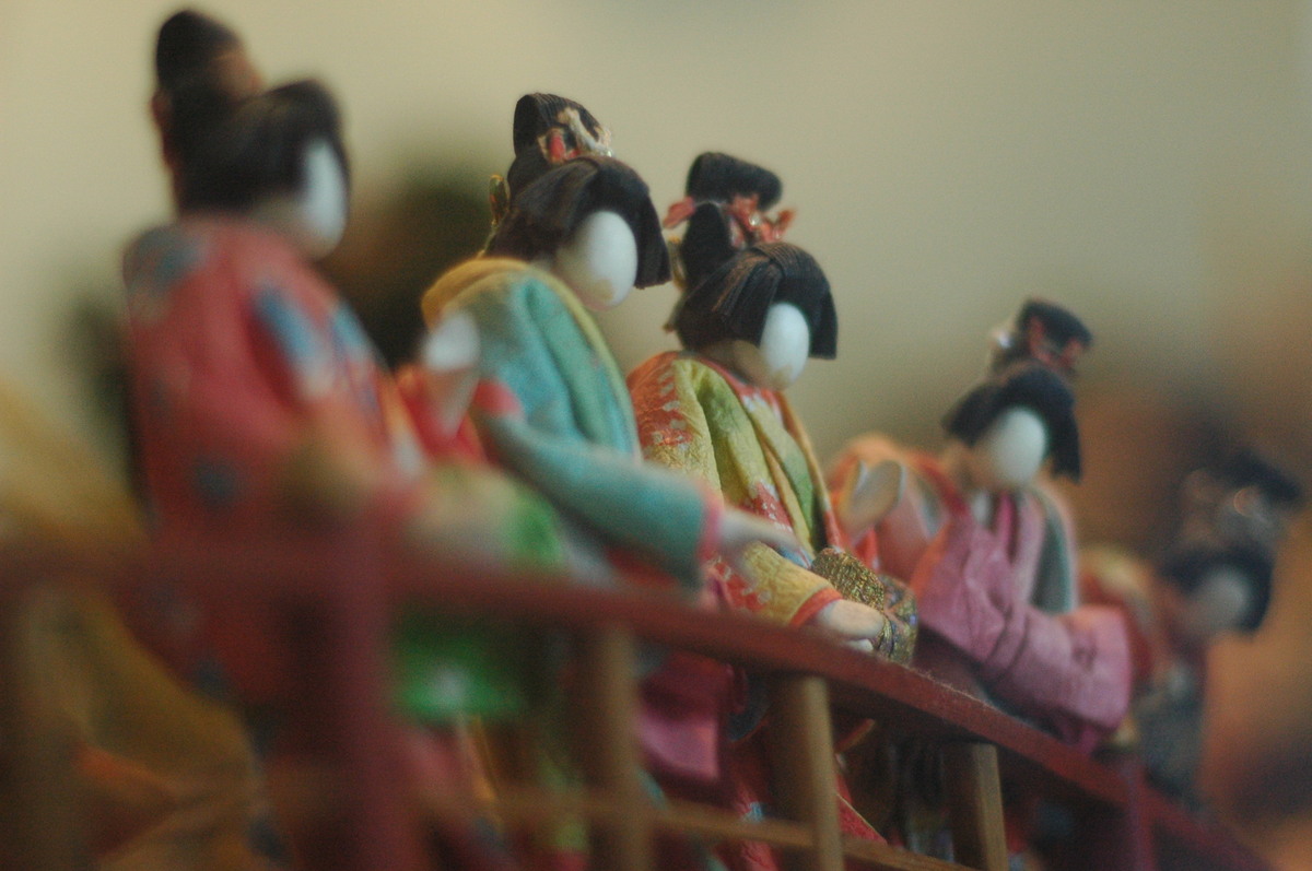 Japanese figures in kimono look out from a bridge